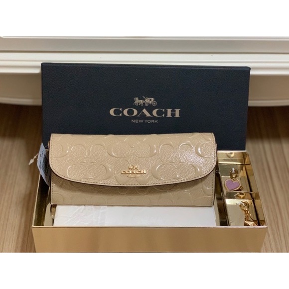 Coach Handbags - LAST ONE LEFT New in box Coach nude patent wallet w/ gold charms
